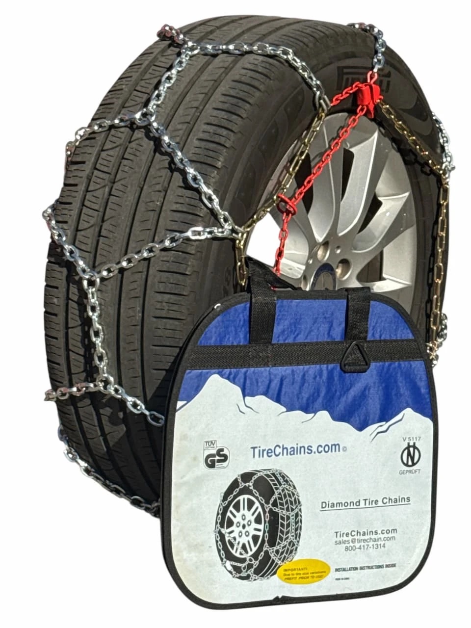 Diamond-pattern snow chains fitted on a car wheel